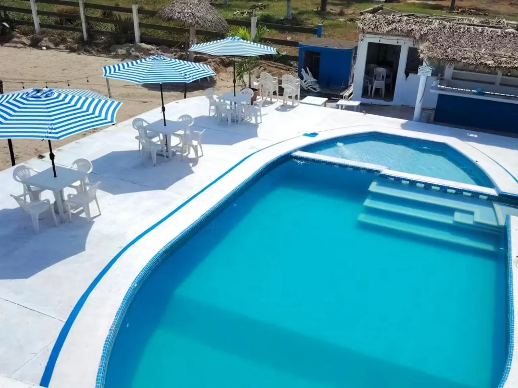 Beachside swimming pool with shaded tables
