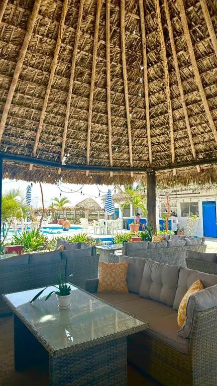 Thatched palapa lounge and pool at Pacha Beach Club
